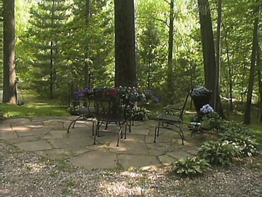 Shrouded Flagstone Patio Nested in Bright, Cheery Flowers Soon to Bloom Year Round